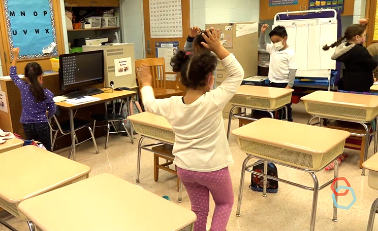 First graders spin three times to transpirt themselves into a 5 senses journey to the zoo.