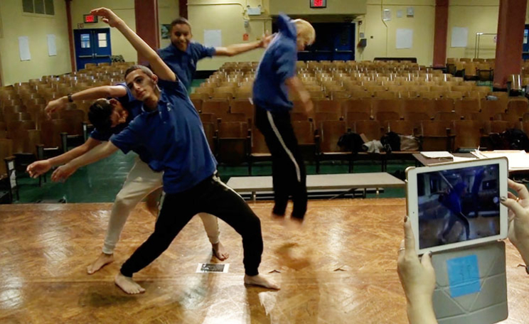 boys-dance-full-body-extension-and-mid-jump-another-student-films-on-ipad